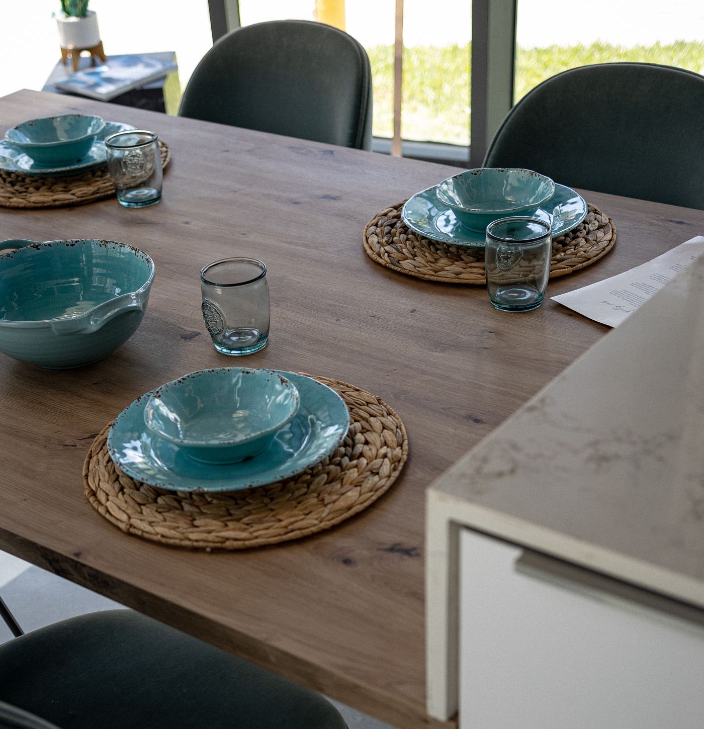 Dining table set for a meal in a Moderno kitchen